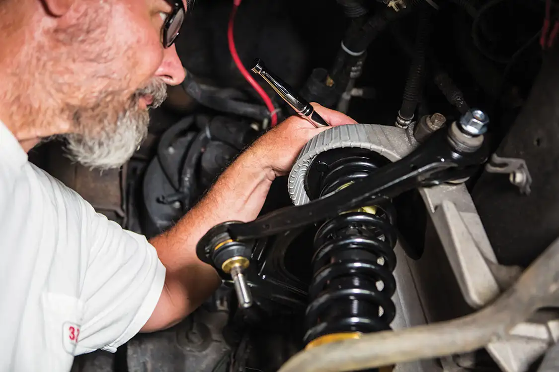 snug up the three bolts on top of the coilover